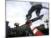 Skateboarder in Midair Knocking Over a Cone-null-Mounted Premium Photographic Print