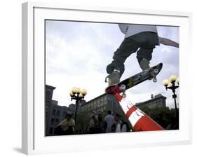 Skateboarder in Midair Knocking Over a Cone-null-Framed Photographic Print