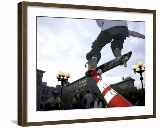 Skateboarder in Midair Knocking Over a Cone-null-Framed Photographic Print