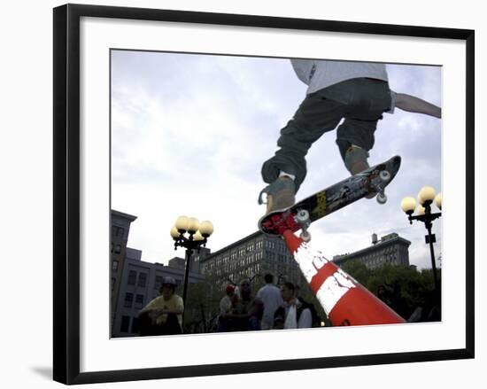 Skateboarder in Midair Knocking Over a Cone-null-Framed Photographic Print