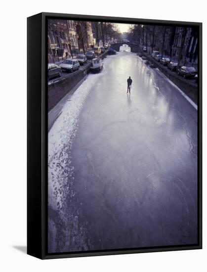 Skater on Frozen Canal, Amsterdam, Netherlands-Michele Molinari-Framed Stretched Canvas