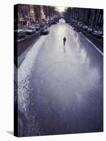 Skater on Frozen Canal, Amsterdam, Netherlands-Michele Molinari-Stretched Canvas