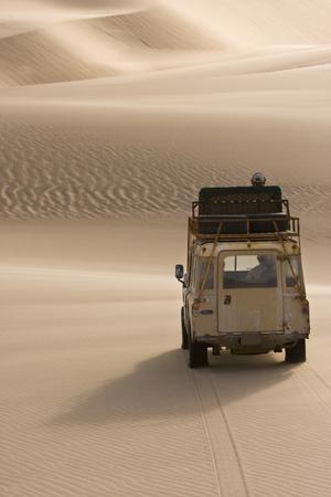 https://imgc.allpostersimages.com/img/posters/skeleton-coast-namibia-land-rover-venturing-out-over-the-sand-dunes_u-L-PYOO480.jpg?artPerspective=n