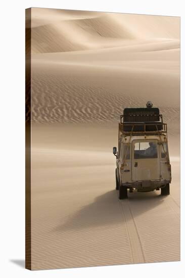 Skeleton Coast, Namibia. Land Rover Venturing Out over the Sand Dunes-Janet Muir-Stretched Canvas