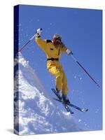 Skier in Yellow Against a Blue Sky-null-Stretched Canvas