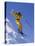 Skier in Yellow Against a Blue Sky-null-Stretched Canvas