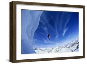 Skier Jumping from Mountain Ledge-null-Framed Photo