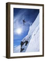 Skier Jumping from Mountain Ledge-null-Framed Photo