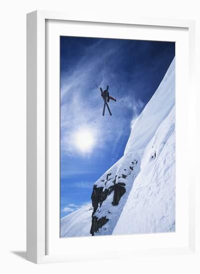 Skier Jumping from Mountain Ledge-null-Framed Photo