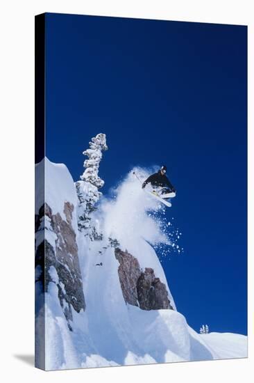 Skier Jumping from Mountain Ledge-null-Stretched Canvas