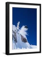 Skier Jumping from Mountain Ledge-null-Framed Photo