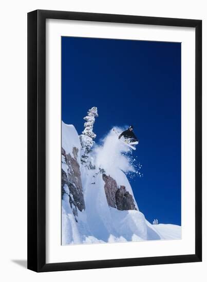 Skier Jumping from Mountain Ledge-null-Framed Photo