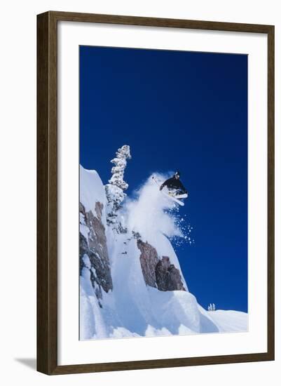 Skier Jumping from Mountain Ledge-null-Framed Photo