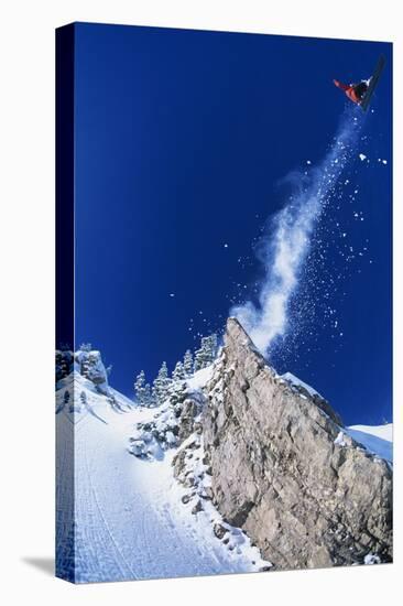 Skier Jumping from Mountain Ledge-null-Stretched Canvas