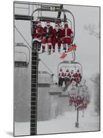 Skiers and Snowboarders Dressed as Santa Claus Ride up the Ski Lift-null-Mounted Photographic Print