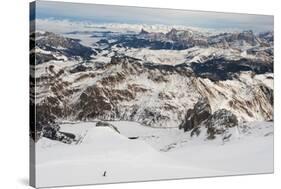 Skiers descend from the top of Marmolada in the Dolomites, Italy, Europe-Alex Treadway-Stretched Canvas