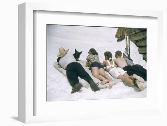 Skiers Sunbathing in Summer Fashions with Dog at Sun Valley Ski Resort, Idaho, April 22, 1947-George Silk-Framed Photographic Print