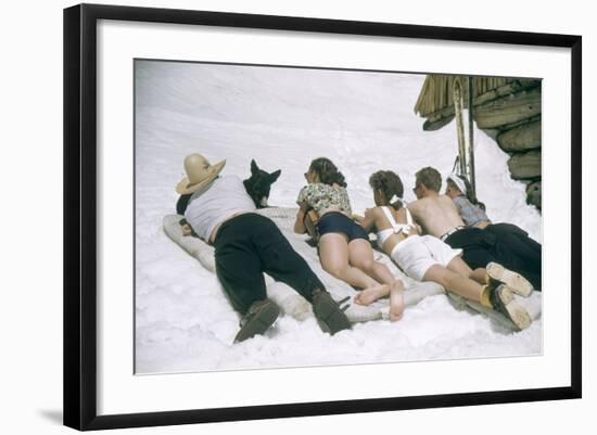 Skiers Sunbathing in Summer Fashions with Dog at Sun Valley Ski Resort, Idaho, April 22, 1947-George Silk-Framed Photographic Print