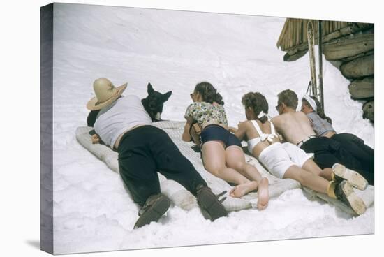 Skiers Sunbathing in Summer Fashions with Dog at Sun Valley Ski Resort, Idaho, April 22, 1947-George Silk-Stretched Canvas
