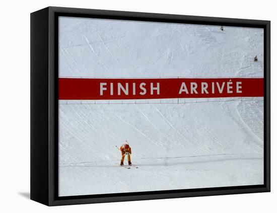 Skiier Arrives at the Finish Line-Paul Sutton-Framed Stretched Canvas