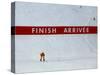 Skiier Arrives at the Finish Line-Paul Sutton-Stretched Canvas