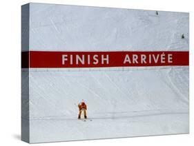 Skiier Arrives at the Finish Line-Paul Sutton-Stretched Canvas