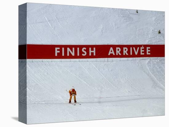 Skiier Arrives at the Finish Line-Paul Sutton-Stretched Canvas