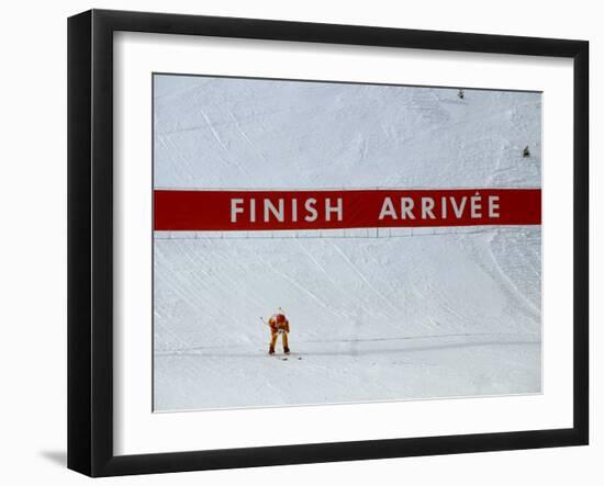 Skiier Arrives at the Finish Line-Paul Sutton-Framed Photographic Print