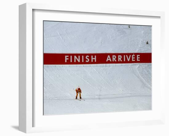 Skiier Arrives at the Finish Line-Paul Sutton-Framed Photographic Print