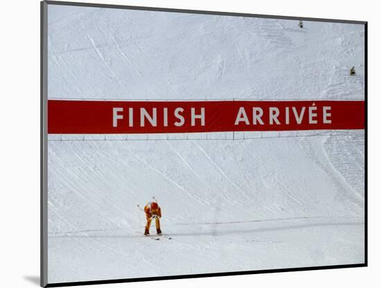 Skiier Arrives at the Finish Line-Paul Sutton-Mounted Photographic Print