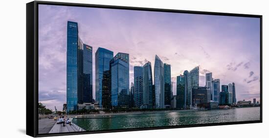 Skyscrapes line Marina Bay at dusk, Singapore, Southeast Asia, Asia-Logan Brown-Framed Stretched Canvas