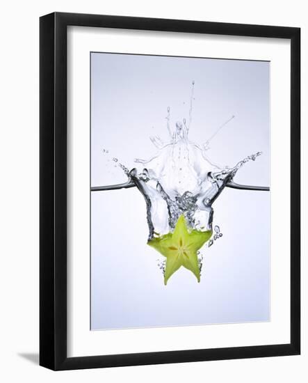 Slice of Carambola Falling into Water-Kröger & Gross-Framed Photographic Print