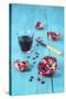 Sliced Pomegranate and a Glass of Pomegranate Juice on Turquoise Wooden Table-Jana Ihle-Stretched Canvas