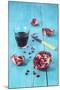 Sliced Pomegranate and a Glass of Pomegranate Juice on Turquoise Wooden Table-Jana Ihle-Mounted Photographic Print