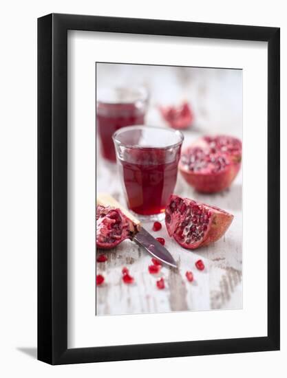 Sliced Pomegranates, Cores and Glass with Pomegranate Juice-Jana Ihle-Framed Photographic Print