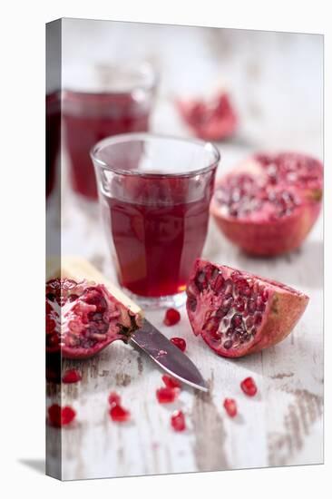 Sliced Pomegranates, Cores and Glass with Pomegranate Juice-Jana Ihle-Stretched Canvas