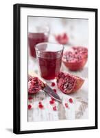 Sliced Pomegranates, Cores and Glass with Pomegranate Juice-Jana Ihle-Framed Photographic Print