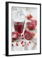 Sliced Pomegranates, Seeds and Glass with Pomegranate Juice-Jana Ihle-Framed Photographic Print