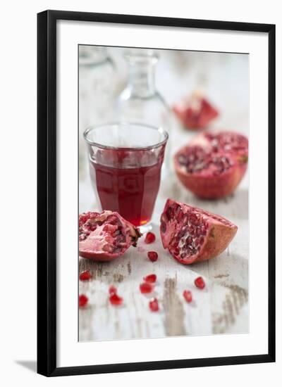 Sliced Pomegranates, Seeds and Glass with Pomegranate Juice-Jana Ihle-Framed Photographic Print