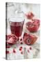 Sliced Pomegranates, Seeds and Glass with Pomegranate Juice-Jana Ihle-Stretched Canvas