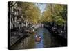 Small Boat on Tree-Lined Oudezijds Achtenburg Wal Canal in the Autumn, Amsterdam, the Netherlands-Richard Nebesky-Stretched Canvas