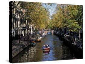 Small Boat on Tree-Lined Oudezijds Achtenburg Wal Canal in the Autumn, Amsterdam, the Netherlands-Richard Nebesky-Stretched Canvas
