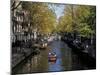 Small Boat on Tree-Lined Oudezijds Achtenburg Wal Canal in the Autumn, Amsterdam, the Netherlands-Richard Nebesky-Mounted Photographic Print