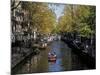Small Boat on Tree-Lined Oudezijds Achtenburg Wal Canal in the Autumn, Amsterdam, the Netherlands-Richard Nebesky-Mounted Photographic Print
