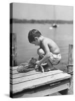 Small Boy Catching Fish with a Net-null-Stretched Canvas