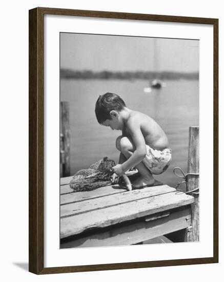 Small Boy Catching Fish with a Net-null-Framed Photographic Print