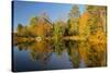 Small bridge and autumn colors reflected on tranquil pond, New Hampshire-Adam Jones-Stretched Canvas