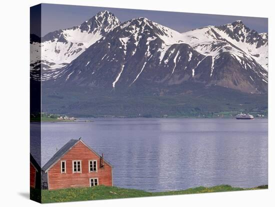 Small Farm Building with Mountains, Harstad, Norway-Walter Bibikow-Stretched Canvas