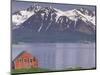 Small Farm Building with Mountains, Harstad, Norway-Walter Bibikow-Mounted Photographic Print