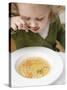 Small Girl Eating Soup with Teddy Bear Pasta-null-Stretched Canvas